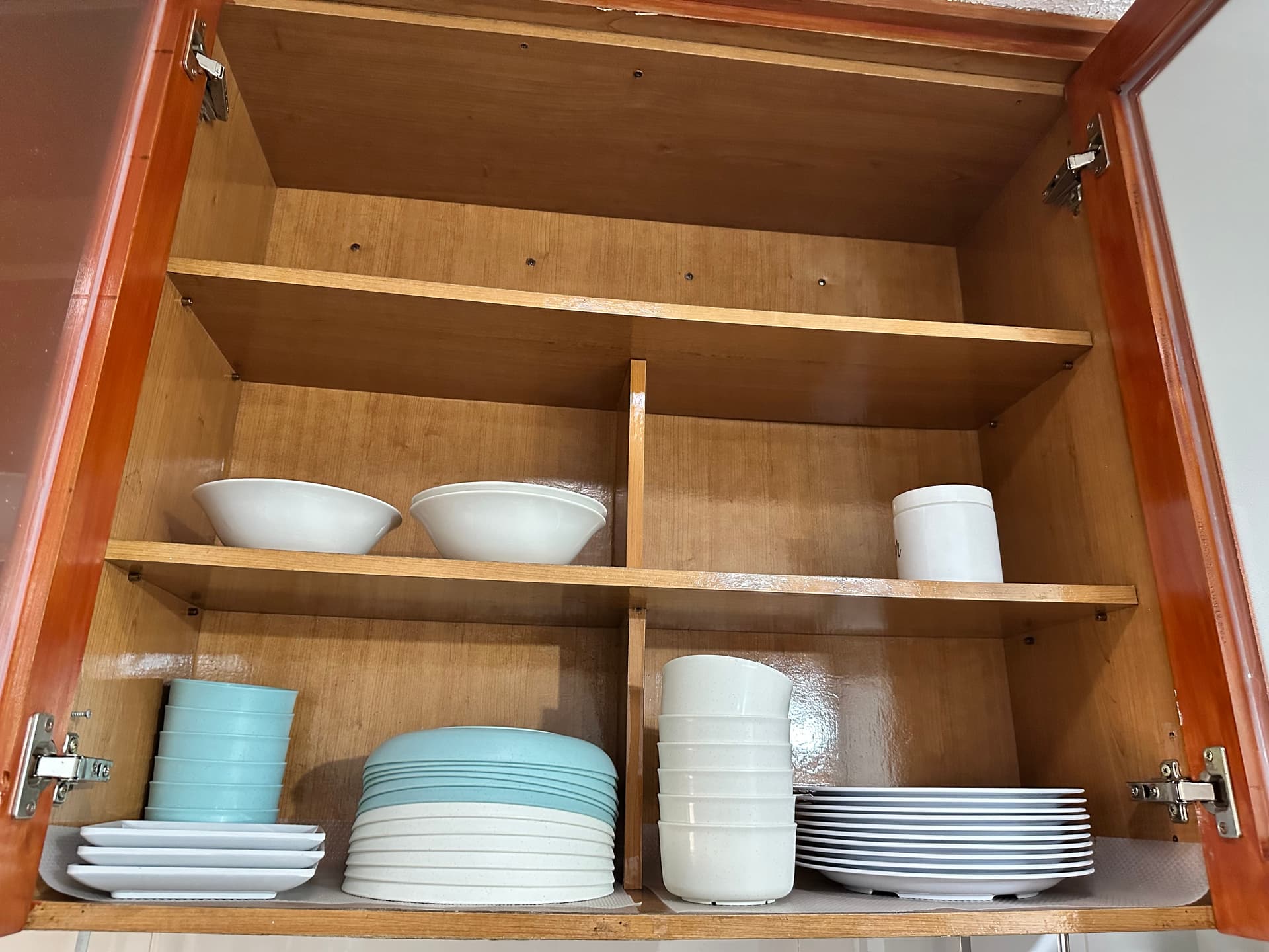 Cabinet stocked with complete plates, bowls and dishes