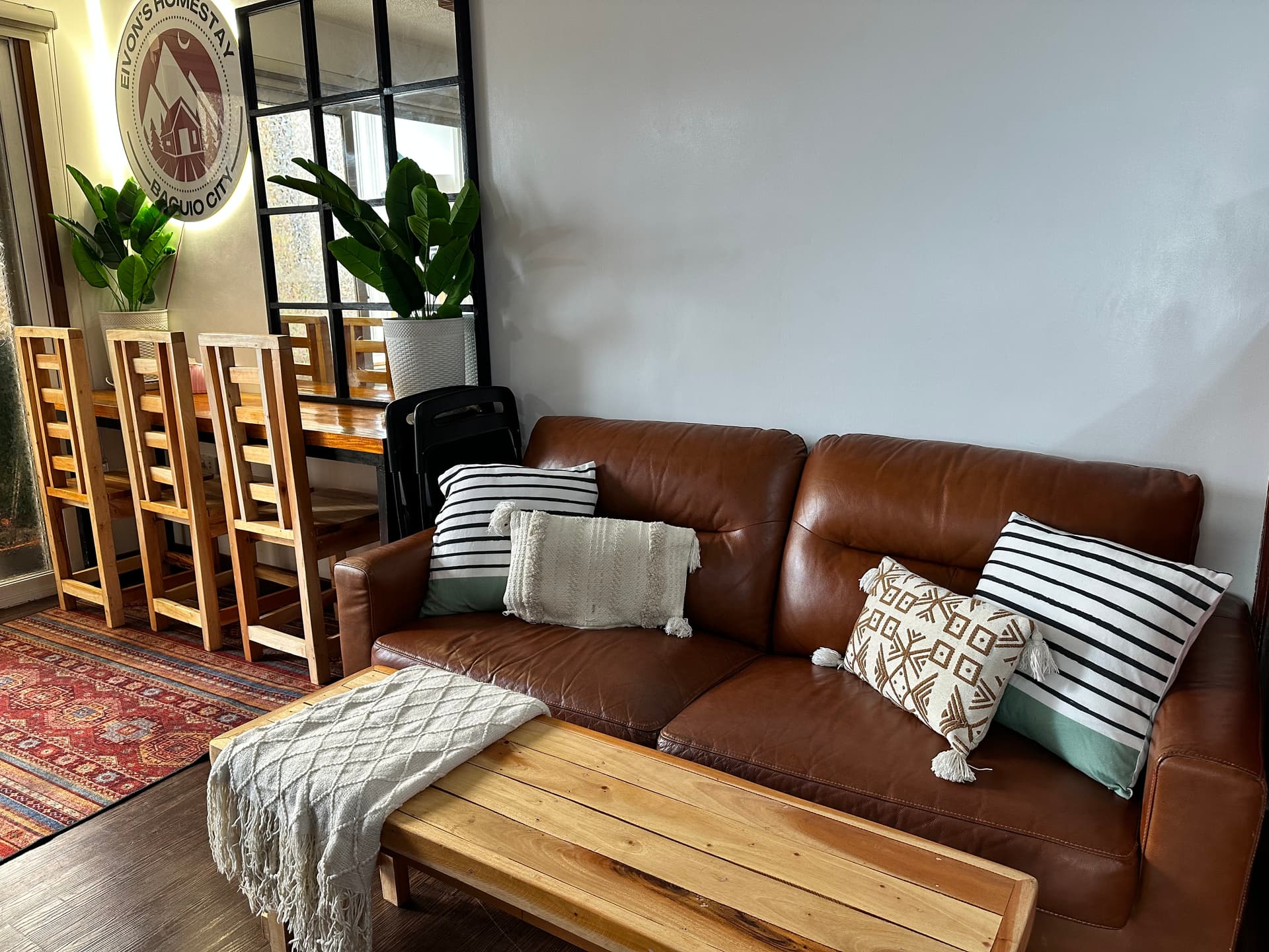 Cozy leather sofa and styled seating area in Unit B304